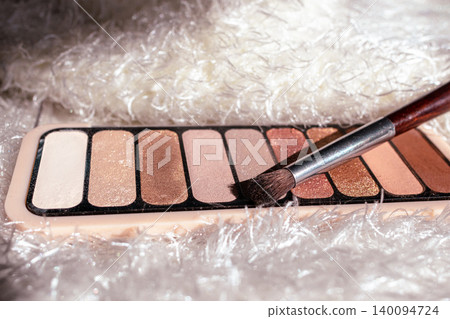 Eyeshadow palette with multiple shimmer and matte shades, featuring a range of warm and neutral tones for beauty looks Eyeshadow palette with multiple shimmer and matte shades, featuring a range of warm and neutral tones for beauty looks 140094724