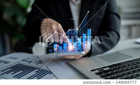 Business professional analyzing growth data using digital charts and graphs on a smartphone in a modern office environment with laptop and documents Scalp Business professional analyzing growth data using digital charts and graphs on a smartphone in a modern office environment with laptop and documents Scalp 140094777