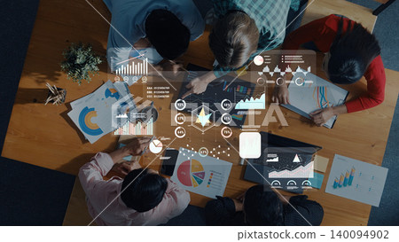 Team Collaboration in Business Meeting Using Data Analysis Software with Graphs, Charts, and Visualizations on a Wooden Table with Laptops Trope Team Collaboration in Business Meeting Using Data Analysis Software with Graphs, Charts, and Visualizations on a Wooden Table with Laptops Trope 140094902
