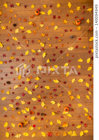 Scattered red maple leaves, ginkgo leaves, pine cones, and persimmons – an image of autumn. Scattered red maple leaves, ginkgo leaves, pine cones, and persimmons – an image of autumn. 140094949