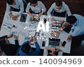 Group of Business Professionals Collaborating on Artificial Intelligence Project with Digital Graphics Representing AI Technology in Modern Office Trope 140094969