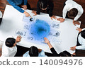 Diverse Group Engaged in Data Analysis Over Table with Graphs and Charts, Emphasizing Collaboration and Technology in Business Settings Trope 140094976