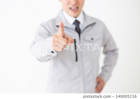 A middle-aged businessman in gray work clothes engaging in power harassment (white background) A middle-aged businessman in gray work clothes engaging in power harassment (white background) 140095216
