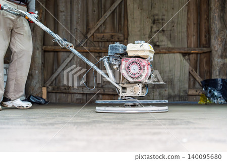 Power Floater in Action Concrete Finishing with a Trowel Machine for a Smooth Surface and Even Power Floater in Action Concrete Finishing with a Trowel Machine for a Smooth Surface and Even 140095680