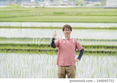 A rice farmer gives a thumbs-up. A rice farmer gives a thumbs-up. 140095732