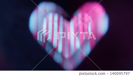 Romantic background. Blur love symbol. Defocused pink blue color sparkle lens glare shine flicker gleam on abstract dark black art. Romantic background. Blur love symbol. Defocused pink blue color sparkle lens glare shine flicker gleam on abstract dark black art. 140095797