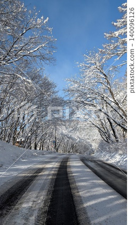 A road stretching across a snowy landscape A road stretching across a snowy landscape 140096126