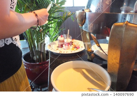 A woman's hands enjoying a buffet A woman's hands enjoying a buffet 140097690
