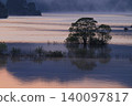 A fantastical lake landscape shrouded in morning mist. 140097817