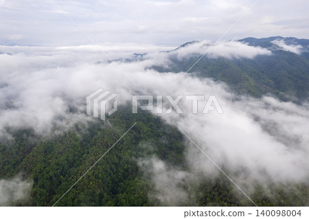 Landscape of Morning Mist with Mountain Layer. mountain ridge and clouds in rural jungle bush forest Landscape of Morning Mist with Mountain Layer. mountain ridge and clouds in rural jungle bush forest 140098004