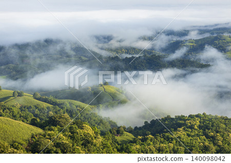 Landscape of Morning Mist with Mountain Layer. mountain ridge and clouds in rural jungle bush forest Landscape of Morning Mist with Mountain Layer. mountain ridge and clouds in rural jungle bush forest 140098042