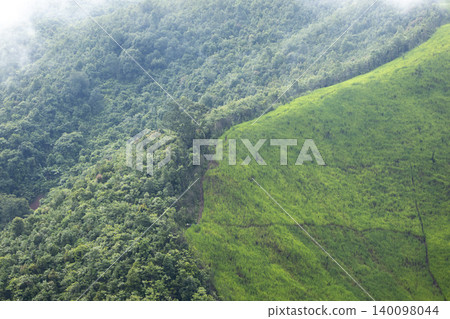 Landscape of Morning Mist with Mountain Layer. mountain ridge and clouds in rural jungle bush forest 140098044