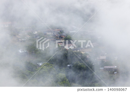 Landscape of Morning Mist with Mountain Layer. mountain ridge and clouds in rural jungle bush forest Landscape of Morning Mist with Mountain Layer. mountain ridge and clouds in rural jungle bush forest 140098067