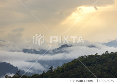 Landscape of Morning Mist with Mountain Layer. mountain ridge and clouds in rural jungle bush forest Landscape of Morning Mist with Mountain Layer. mountain ridge and clouds in rural jungle bush forest 140098079