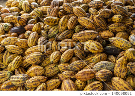 Cocoa beans and cocoa pod on a wooden surface. Cocoa beans and cocoa pod on a wooden surface. 140098091