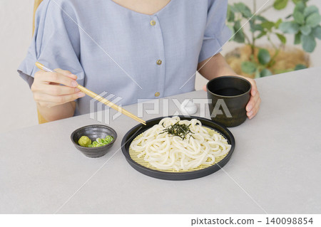 A woman eating zaru udon in the living room (faceless) A woman eating zaru udon in the living room (faceless) 140098854