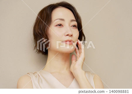Middle-aged woman portrait brown background Middle-aged woman portrait brown background 140098881