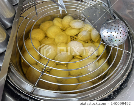 Filming Taiwanese fried meatballs sold in a deep fryer Filming Taiwanese fried meatballs sold in a deep fryer 140099492