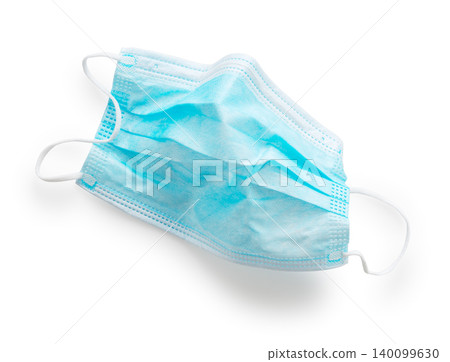 A single disposable non-woven surgical mask, isolated against a white background, viewed from directly above. A single disposable non-woven surgical mask, isolated against a white background, viewed from directly above. 140099630