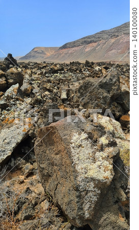 Wide view of Lanzarote desert landscape with volcanic hills and stark island beauty 140100080