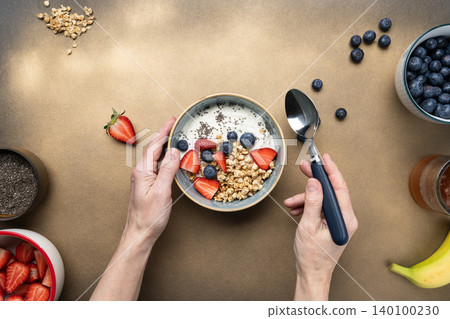 Woman eating healthy breakfast yogurt berries Woman eating healthy breakfast yogurt berries 140100230