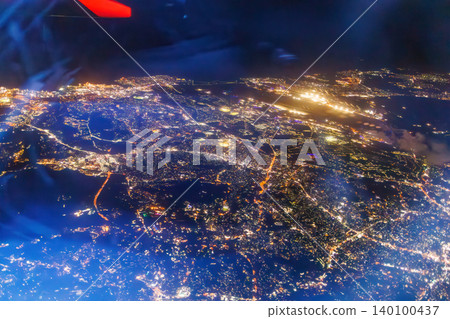A view from the window of a passenger plane flying from Haneda Airport to Naha. A night view of Japan from 10,000 meters above ground. Naha Airport, Naha City, Okinawa Prefecture. A view from the window of a passenger plane flying from Haneda Airport to Naha. A night view of Japan from 10,000 meters above ground. Naha Airport, Naha City, Okinawa Prefecture. 140100437