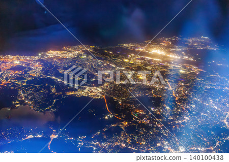 A view from the window of a passenger plane flying from Haneda Airport to Naha. A night view of Japan from 10,000 meters above ground. Naha Airport, Naha City, Okinawa Prefecture. A view from the window of a passenger plane flying from Haneda Airport to Naha. A night view of Japan from 10,000 meters above ground. Naha Airport, Naha City, Okinawa Prefecture. 140100438