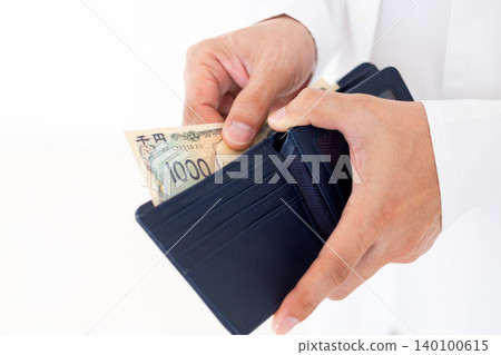 A middle-aged man takes money out of his wallet. A middle-aged man takes money out of his wallet. 140100615
