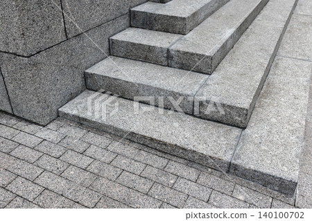 Abstract photo of granite steps highlighting sharp geometric lines, rough stone texture Abstract photo of granite steps highlighting sharp geometric lines, rough stone texture 140100702