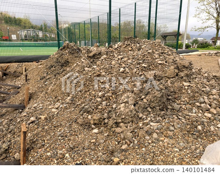 Reconstruction of an open sports ground, a pile of gravel and earth. A new recreational or infrastructure project. 140101484