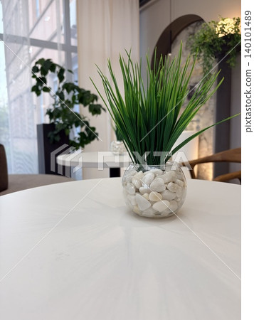 A modern lounge area with tables and upholstered furniture. A cafe area. Decorative design elements on a cafe table A modern lounge area with tables and upholstered furniture. A cafe area. Decorative design elements on a cafe table 140101489