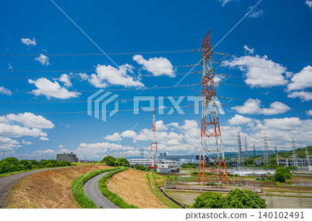 A power transmission tower standing in the middle of a rural landscape, Takatsuki City, Osaka Prefecture. 140102491