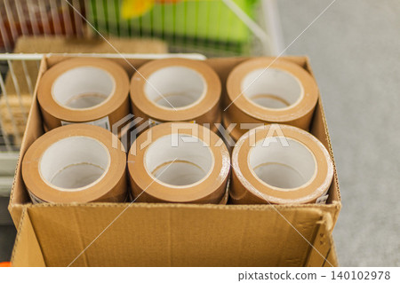 Packing tape rolls in cardboard box at hardware or household store 140102978