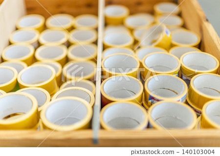 Rolls of adhesive tape arranged in hardware and repair store 140103004