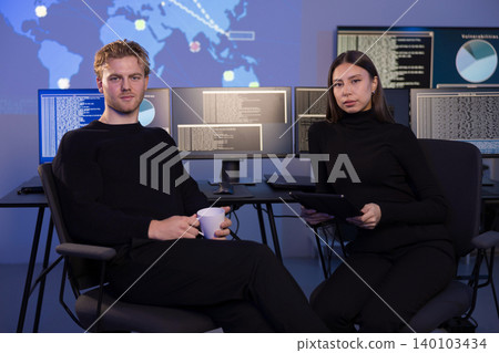Cyber security team analyzing threats in a modern control room 140103434