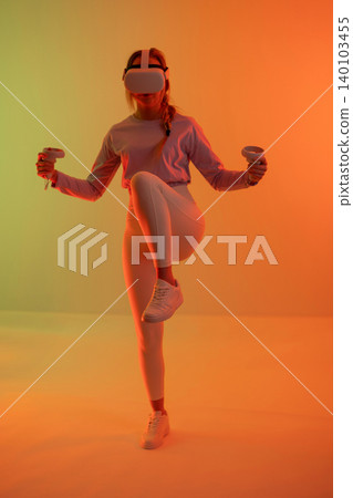 Woman in VR practicing fitness balance 140103455