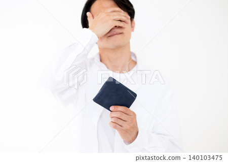 A middle-aged man is shocked when he picks up his wallet. 140103475