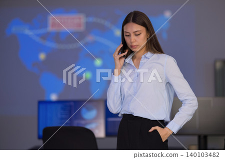 Focused analyst in SOC monitoring global cybersecurity threats on digital dashboards 140103482