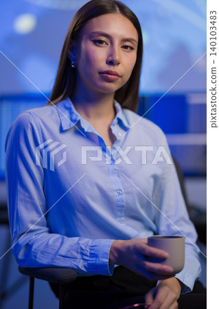 Businesswoman in a Corporate Environment Observing Analytics with Confidence 140103483