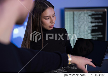 Team discussing cybersecurity issues in a modern SOC environment 140103485