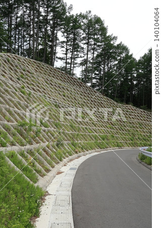 Road scenery in a mountainous area with disaster prevention measures in place. Road scenery in a mountainous area with disaster prevention measures in place. 140104064