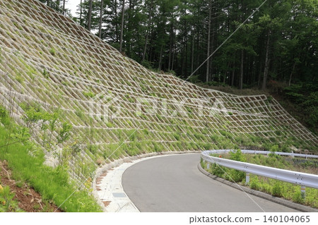 Road scenery in a mountainous area with disaster prevention measures in place. 140104065