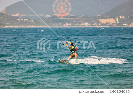 Nha Trang, Khanh Hoa - Vietnam - April 4, 2026: Kitesurfer Cutting Through Waves in Open Sea Nha Trang, Khanh Hoa - Vietnam - April 4, 2026: Kitesurfer Cutting Through Waves in Open Sea 140104085