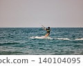 Nha Trang, Khanh Hoa - Vietnam - April 4, 2026: Kitesurfer Cutting Through Waves in Open Sea 140104095