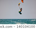 Nha Trang, Khanh Hoa, Vietnam - April 5, 2026: Kitesurfer Performing High Jump Above Waves in Nha Trang 140104100