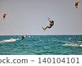 Nha Trang, Khanh Hoa, Vietnam - April 5, 2026: Kitesurfer Performing High Jump Above Waves in Nha Trang 140104101