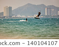 Nha Trang, Khanh Hoa, Vietnam - April 5, 2026: Kitesurfer Performing High Jump Above Waves in Nha Trang 140104107
