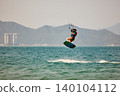 Nha Trang, Khanh Hoa, Vietnam - April 6, 2026: Kitesurfer Performing High Jump Above Waves in Nha Trang 140104112