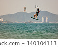 Nha Trang, Khanh Hoa, Vietnam - April 6, 2026: Kitesurfer Performing High Jump Above Waves in Nha Trang 140104113