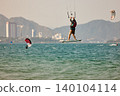 Nha Trang, Khanh Hoa, Vietnam - April 6, 2026: Kitesurfer Performing High Jump Above Waves in Nha Trang 140104114